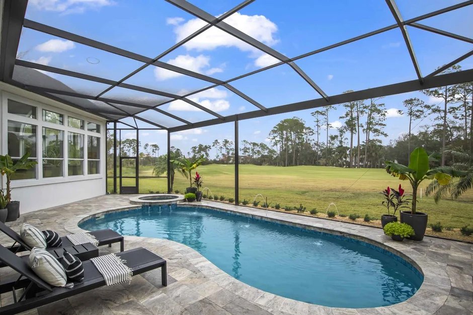 Custom pool enclosure installation in Cocoa, FL over residential backyard swimming pool