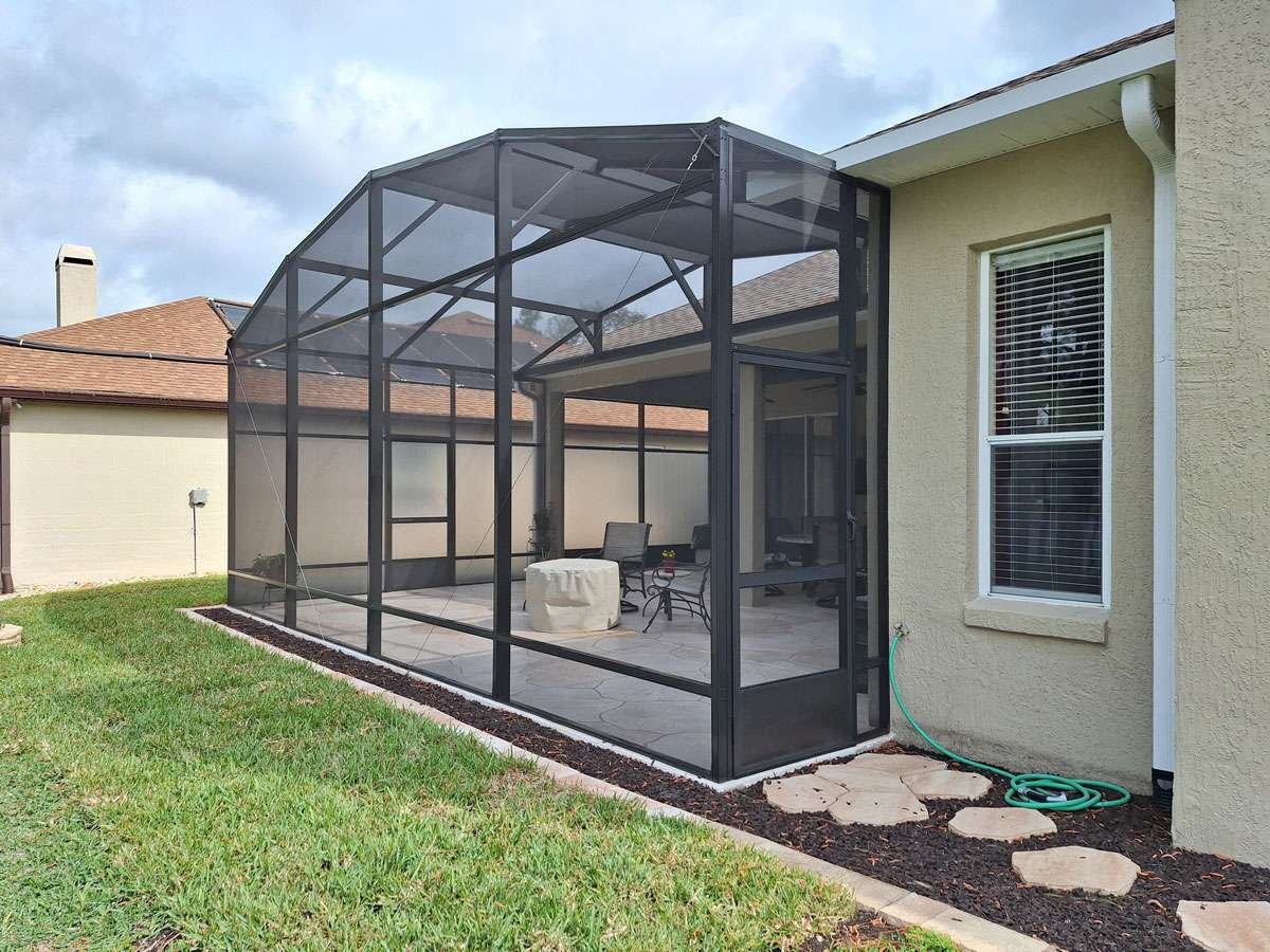 Residential lanai screen enclosure installation in Cocoa, FL on backyard patio area